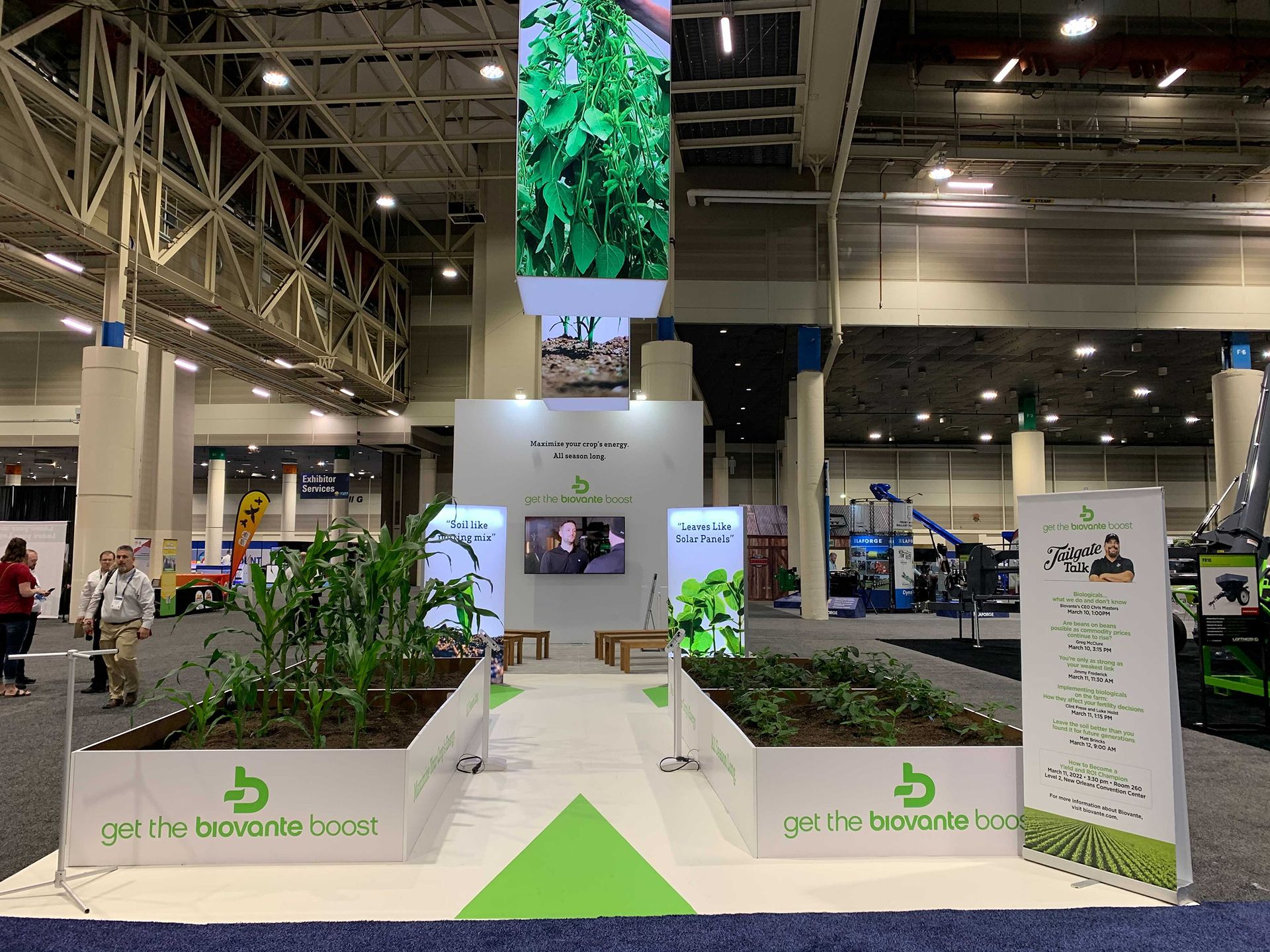 Digital rendering of a modern Biovante trade show booth design with crop field graphics.