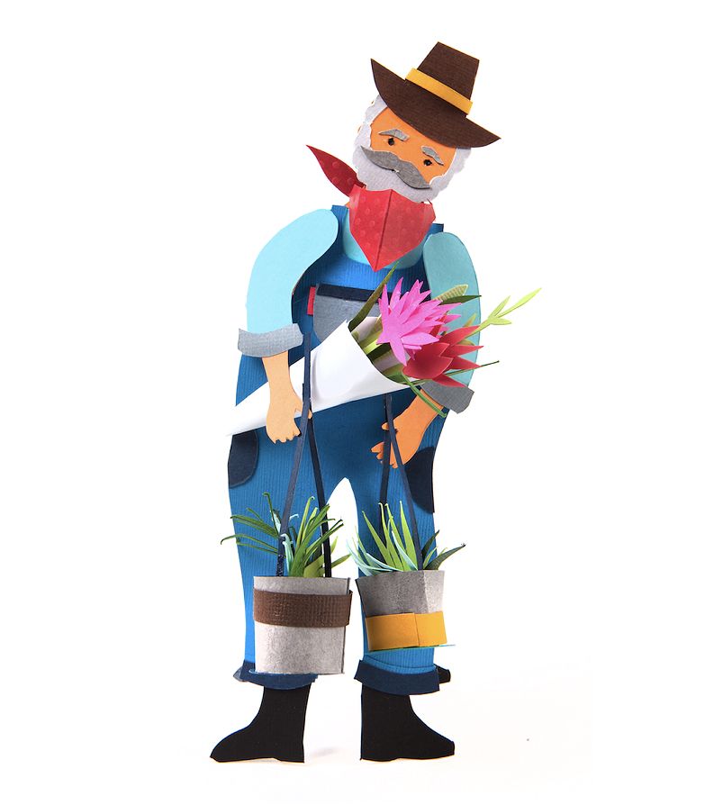 Close-up of a paper craft sculpture of an elderly male farmer character: a bearded figure in a brown cowboy hat, red bandana, blue overalls, and black boots, cradling a vivid pink paper-cut flower bouquet while carrying two small potted plants at his sides.