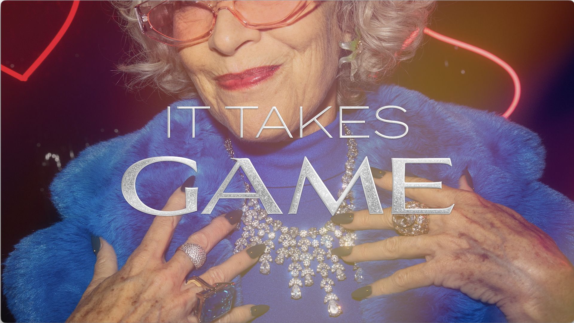 Close-up of an elderly woman wearing a blue fur coat and a large diamond necklace, with the text 'IT TAKES GAME' superimposed on the image.